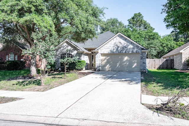 4523 Bridgevillage Dr, Spring, TX 77373 - ranch-style house with a garage, driveway, and stone siding