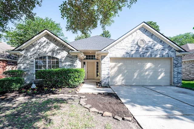 4523 Bridgevillage Dr, Spring, TX 77373 - view of front of home with an attached garage, concrete driveway, and a shingled roof