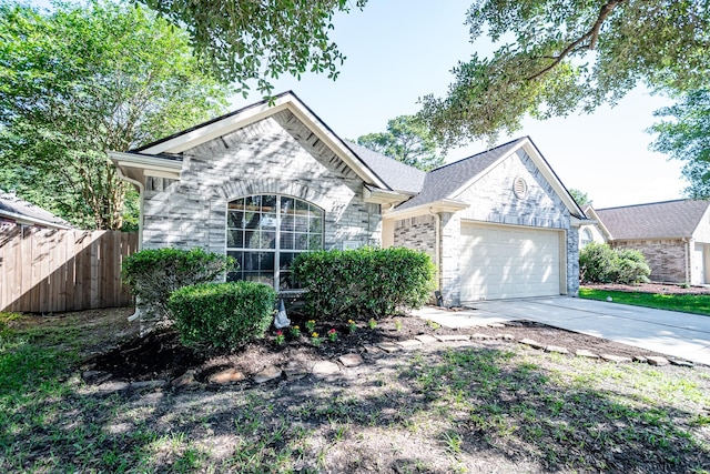 4523 Bridgevillage Dr, Spring, TX 77373 - french provincial home with a garage, stone siding, concrete driveway, and fence