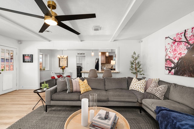 13919 Kimberley Ln, Houston, TX 77079 - living room with beamed ceiling, light wood-style floors, a chandelier, and ceiling fan