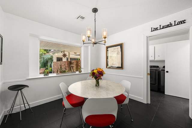 13919 Kimberley Ln, Houston, TX 77079 - dining space with separate washer and dryer, dark tile patterned floors, and a chandelier