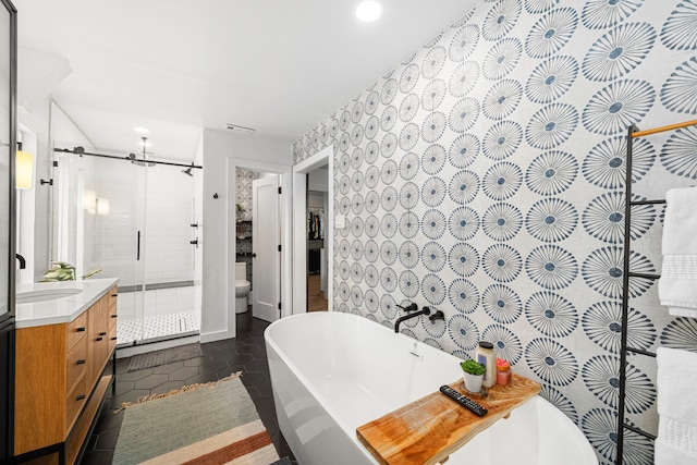 13919 Kimberley Ln, Houston, TX 77079 - full bath featuring a stall shower, vanity, recessed lighting, a freestanding bath, and toilet