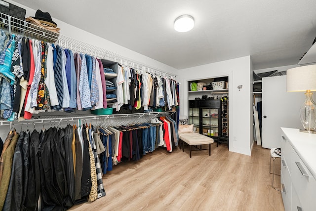 13919 Kimberley Ln, Houston, TX 77079 - walk in closet with light wood finished floors