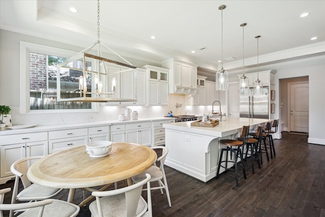 3912 Browning St, West University Place, TX 77005 - kitchen featuring stainless steel built in fridge, dark wood-style flooring, a sink, white cabinets, and crown molding