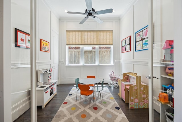 3912 Browning St, West University Place, TX 77005 - recreation room with a decorative wall, dark wood-style flooring, ornamental molding, and a ceiling fan