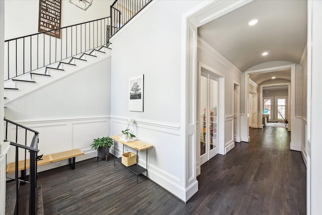 3912 Browning St, West University Place, TX 77005 - corridor featuring stairs, wood finished floors, a decorative wall, arched walkways, and french doors