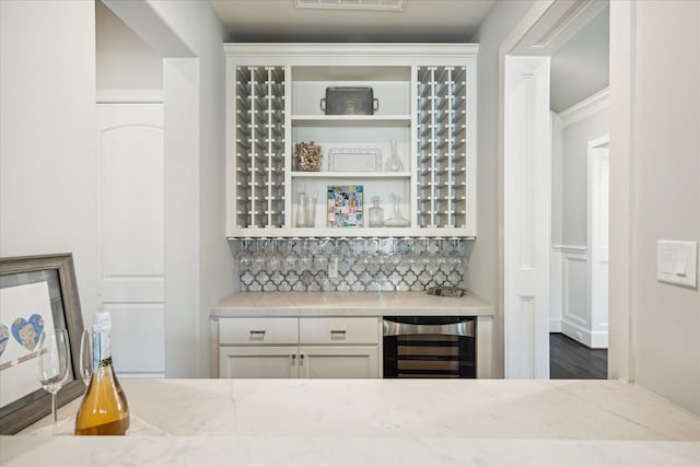 3912 Browning St, West University Place, TX 77005 - indoor dry bar featuring beverage cooler, crown molding, backsplash, and wood finished floors