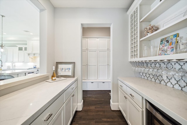 3912 Browning St, West University Place, TX 77005 - bar area with wine cooler, dark wood-style floors, hanging light fixtures, a sink, and stovetop