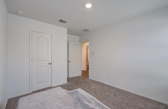 unfurnished bedroom with carpet floors and baseboards