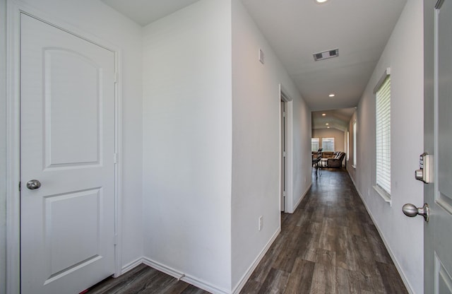 hall featuring dark wood-style flooring, recessed lighting, and baseboards