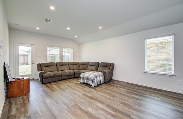 living room featuring wood finished floors, recessed lighting, lofted ceiling, and baseboards