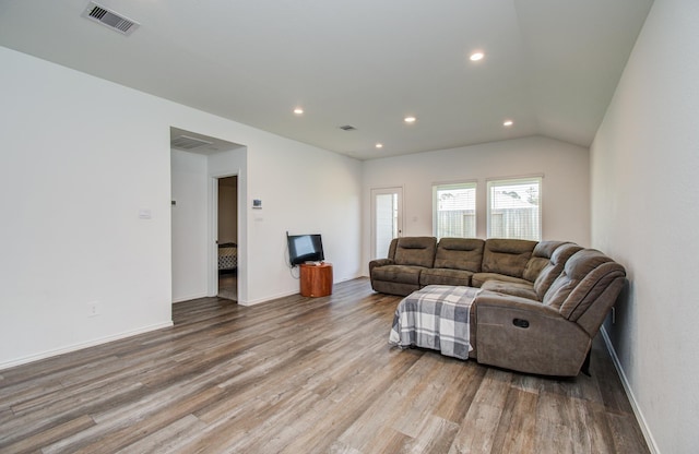 living room with wood finished floors, recessed lighting, baseboards, and lofted ceiling
