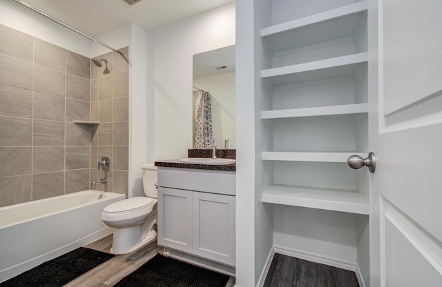 full bathroom with wood finished floors, toilet, vanity, and shower / tub combo with curtain