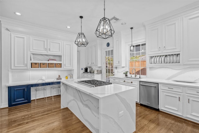 853 Rocky River Rd, Houston, TX 77056 - kitchen with appliances with stainless steel finishes, a sink, white cabinetry, and recessed lighting