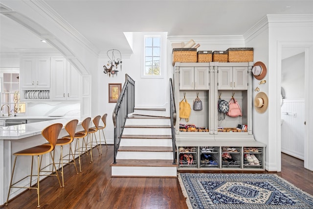 853 Rocky River Rd, Houston, TX 77056 - mudroom featuring dark wood-style floors, ornamental molding, a chandelier, and baseboards