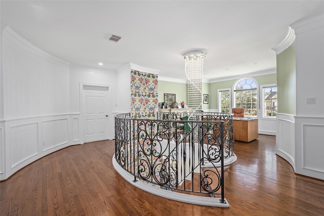 853 Rocky River Rd, Houston, TX 77056 - corridor featuring an upstairs landing, crown molding, wood finished floors, a chandelier, and a decorative wall