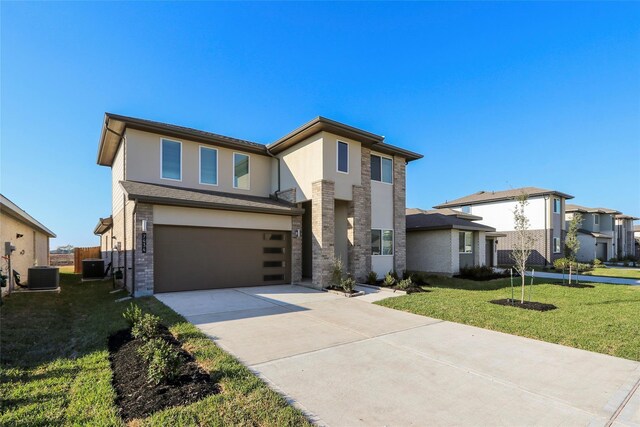 7434 Rivercane Shore Ln, Richmond, TX 77407 - view of front of house featuring central AC, a garage, driveway, and a front yard