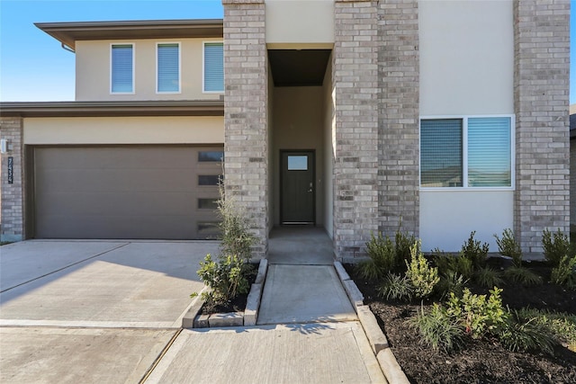 7434 Rivercane Shore Ln, Richmond, TX 77407 - doorway to property featuring stucco siding, concrete driveway, and a garage