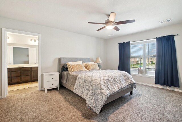 15863 Sundew Prairie Dr, Humble, TX 77346 - bedroom featuring carpet floors, connected bathroom, ceiling fan, and baseboards