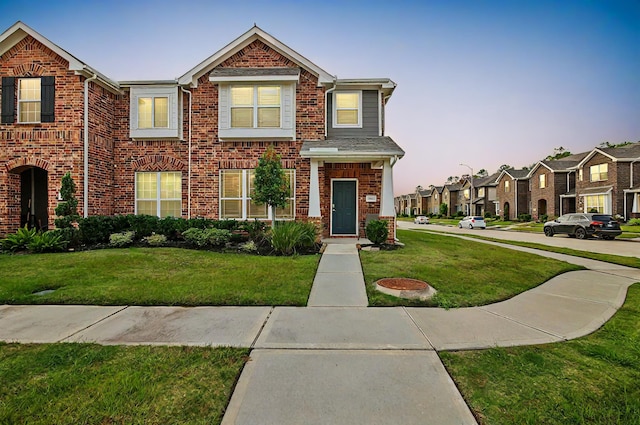 15863 Sundew Prairie Dr, Humble, TX 77346 - view of front of house featuring brick siding, a front lawn, and a residential view