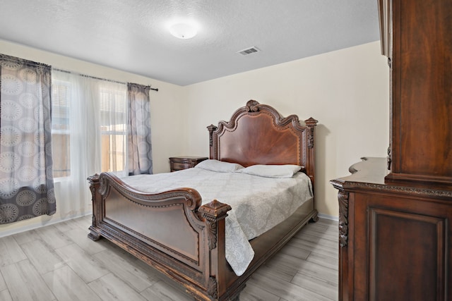 8006 Saffron Ln, Baytown, TX 77521 - bedroom featuring a textured ceiling and baseboards