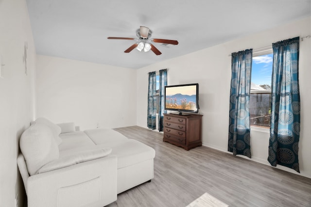 8006 Saffron Ln, Baytown, TX 77521 - living room with healthy amount of natural light, ceiling fan, light wood finished floors, and baseboards