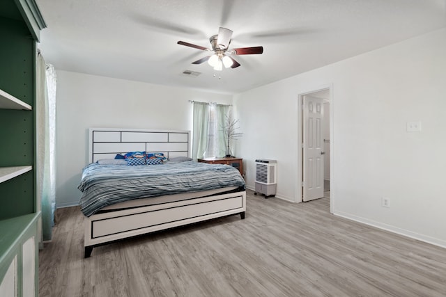 8006 Saffron Ln, Baytown, TX 77521 - bedroom featuring wood finished floors, baseboards, and a ceiling fan