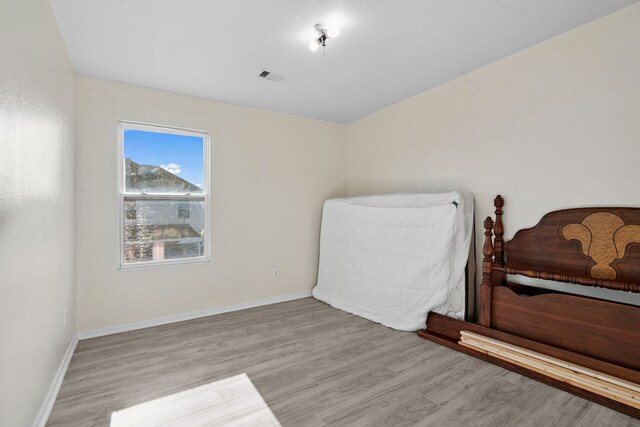 8006 Saffron Ln, Baytown, TX 77521 - bedroom featuring wood finished floors and baseboards