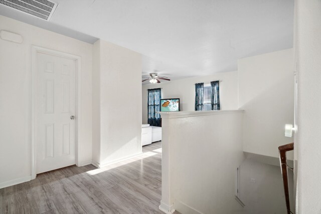 8006 Saffron Ln, Baytown, TX 77521 - hallway with wood finished floors, an upstairs landing, and baseboards