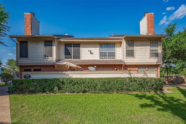 2211 S Kirkwood Rd Unit 19, Houston, TX 77077 - back of house with a chimney, brick siding, and a lawn