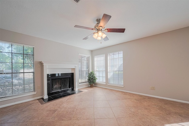 2211 S Kirkwood Rd Unit 19, Houston, TX 77077 - unfurnished living room with baseboards, light tile patterned floors, a ceiling fan, and a tiled fireplace