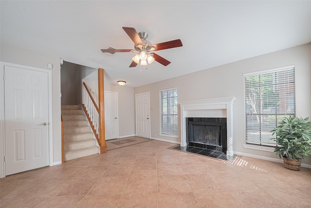 2211 S Kirkwood Rd Unit 19, Houston, TX 77077 - unfurnished living room with stairs, a ceiling fan, a fireplace with flush hearth, baseboards, and light tile patterned floors