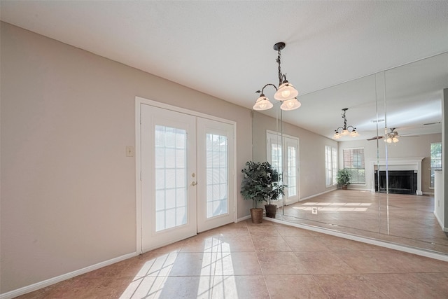 2211 S Kirkwood Rd Unit 19, Houston, TX 77077 - entryway featuring french doors, a chandelier, baseboards, and a fireplace