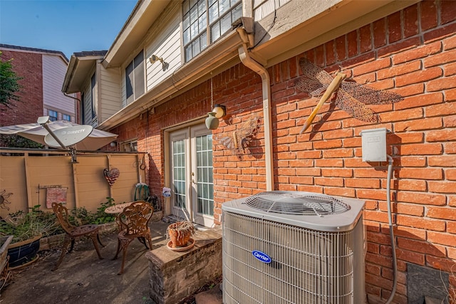 2211 S Kirkwood Rd Unit 19, Houston, TX 77077 - view of patio with central AC and french doors