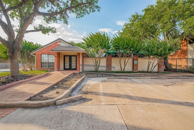 2211 S Kirkwood Rd Unit 19, Houston, TX 77077 - view of front of property with french doors, brick siding, and fence