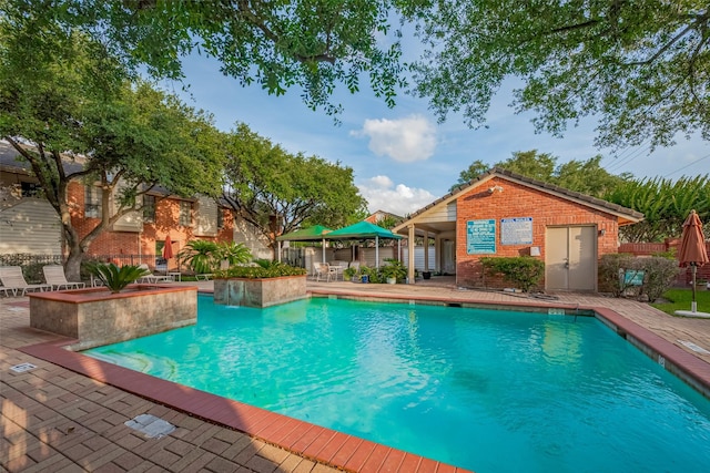 2211 S Kirkwood Rd Unit 19, Houston, TX 77077 - community pool with a patio area, an outbuilding, and fence