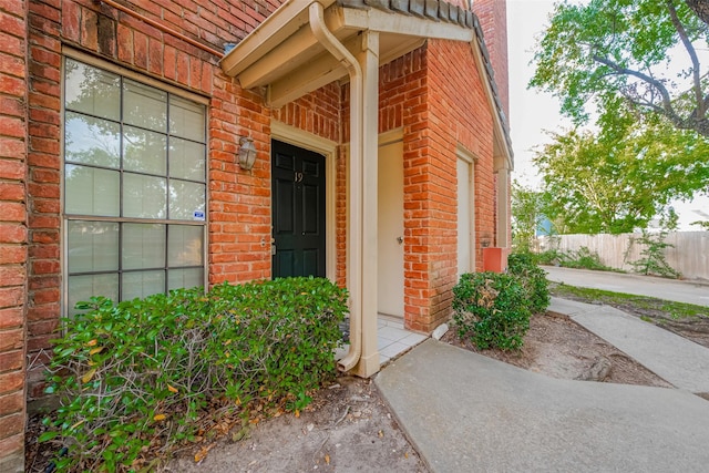 2211 S Kirkwood Rd Unit 19, Houston, TX 77077 - view of exterior entry with brick siding and fence