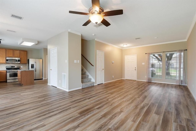15422 Elm Leaf Pl, Cypress, TX 77429 - unfurnished living room featuring stairs, light wood-style flooring, ornamental molding, a ceiling fan, and baseboards