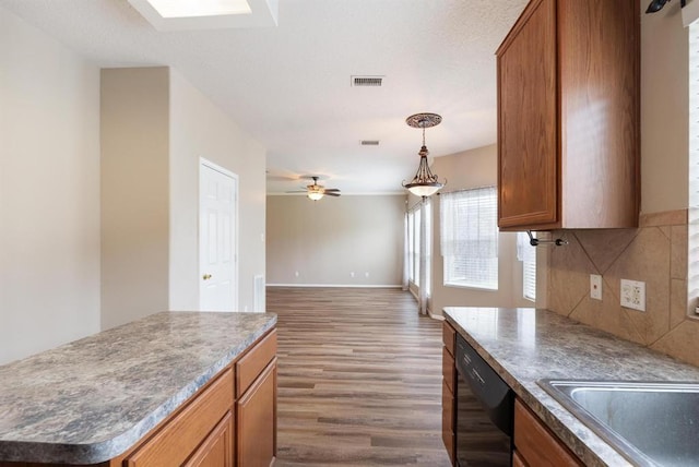 15422 Elm Leaf Pl, Cypress, TX 77429 - kitchen featuring dishwasher, brown cabinets, wood finished floors, decorative backsplash, and ceiling fan