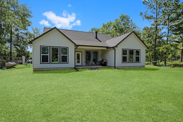 16709 W Rayburn Dr, Conroe, TX 77302 - back of house featuring a yard, roof with shingles, and a patio