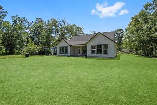 16709 W Rayburn Dr, Conroe, TX 77302 - rear view of house with a lawn