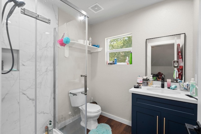 16709 W Rayburn Dr, Conroe, TX 77302 - full bath featuring a marble finish shower, wood finished floors, vanity, toilet, and baseboards