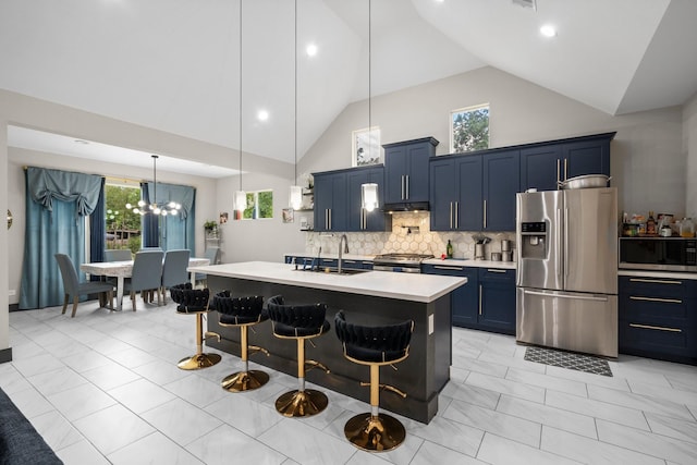 16709 W Rayburn Dr, Conroe, TX 77302 - kitchen featuring appliances with stainless steel finishes, blue cabinets, a sink, light countertops, and high vaulted ceiling