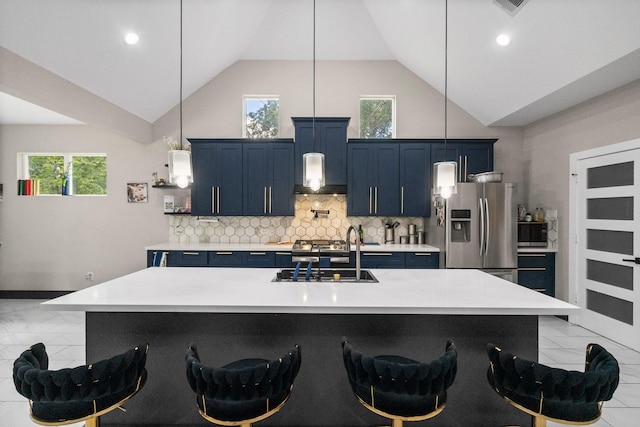 16709 W Rayburn Dr, Conroe, TX 77302 - kitchen with blue cabinetry, appliances with stainless steel finishes, high vaulted ceiling, light countertops, and a sink