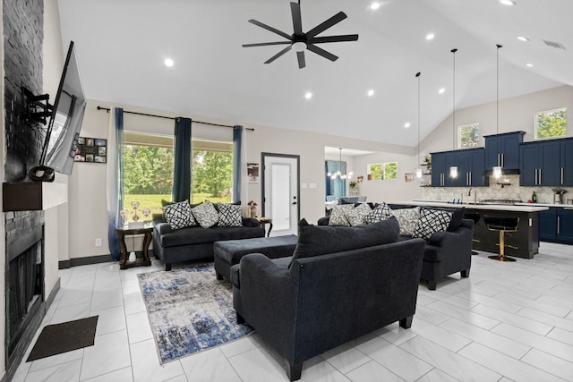 16709 W Rayburn Dr, Conroe, TX 77302 - living area with high vaulted ceiling, a ceiling fan, a fireplace, a chandelier, and recessed lighting
