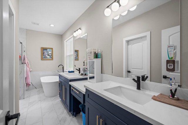 16709 W Rayburn Dr, Conroe, TX 77302 - bathroom featuring marble look tile flooring, a soaking tub, recessed lighting, and two vanities
