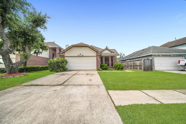 15153 Grassington Dr, Channelview, TX 77530 - ranch-style house with brick siding, a front lawn, driveway, and a garage