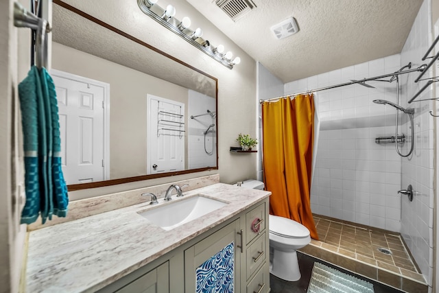 15153 Grassington Dr, Channelview, TX 77530 - full bathroom with toilet, a tile shower, a textured ceiling, and vanity