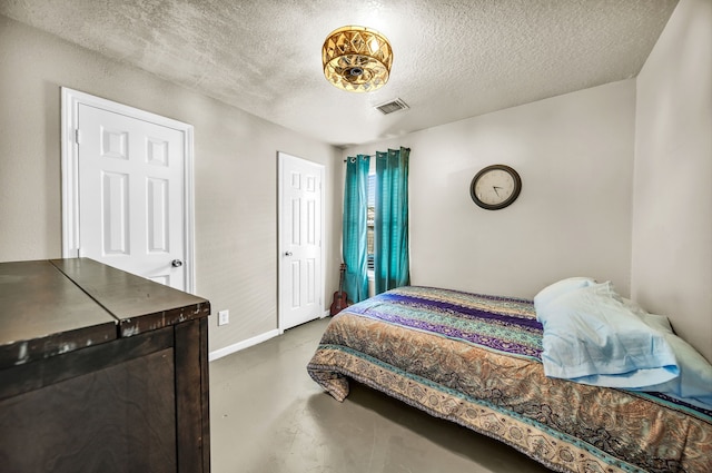 15153 Grassington Dr, Channelview, TX 77530 - bedroom with finished concrete floors, a textured ceiling, and baseboards