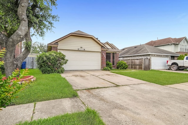 15153 Grassington Dr, Channelview, TX 77530 - view of front of home with brick siding, driveway, and a garage